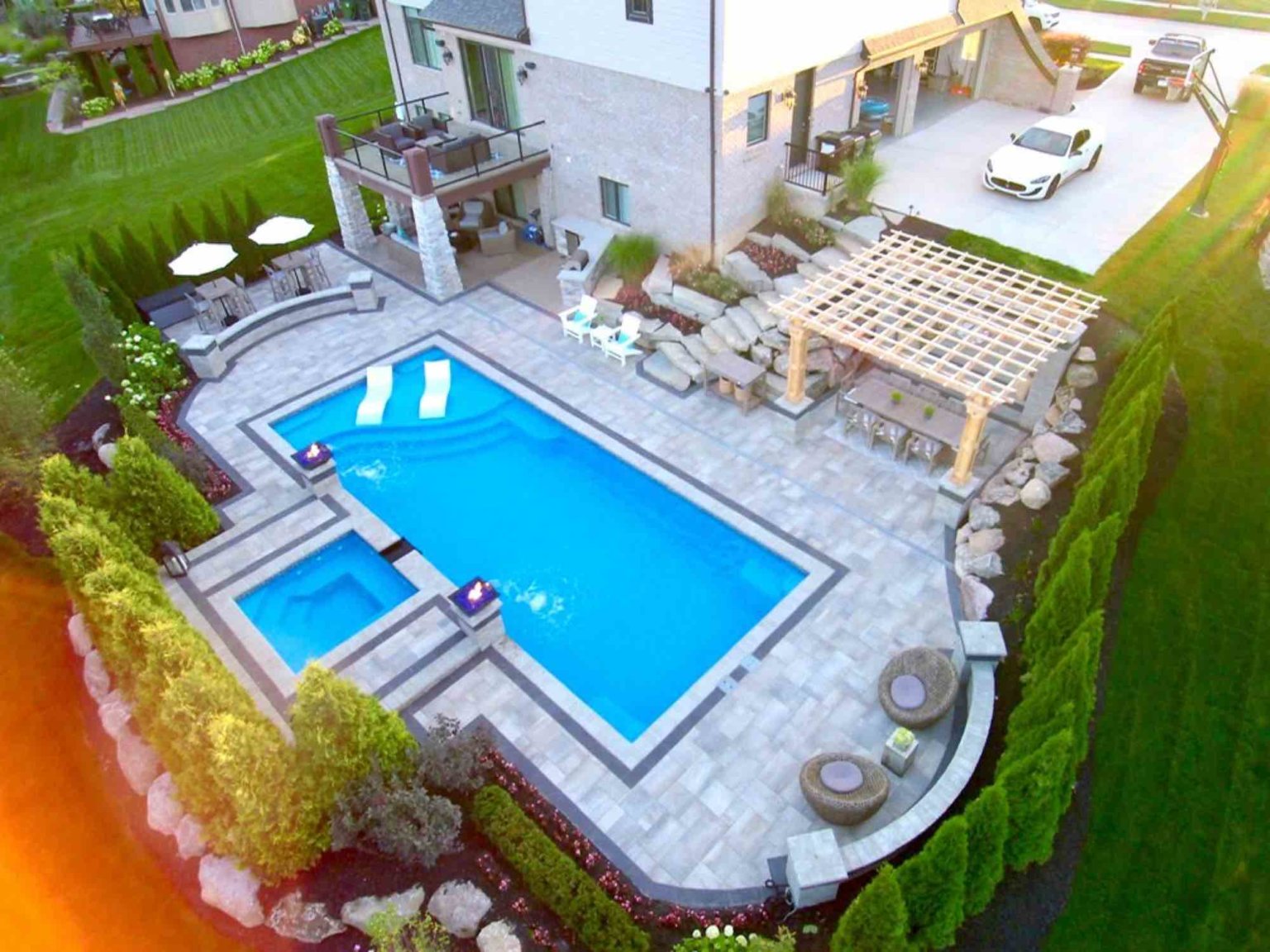 fiberglass pool designers in Shelby Twp, Mi landscape design project in Shelby Township cascade fiberglass swimming pool design with a raised spillover spa  Michigan Landscape Design Landscape Design Services in Michigan Professional Landscape Design Michigan Michigan Landscape Architects Best Landscape Designers in Michigan pool and spa design Metro Detroit Metro Detroit pool and spa experts Custom pool design Metro Detroit Spa installation in Metro Detroit Metro Detroit outdoor spa design Residential pool design Metro Detroit Metro Detroit luxury pool and spa