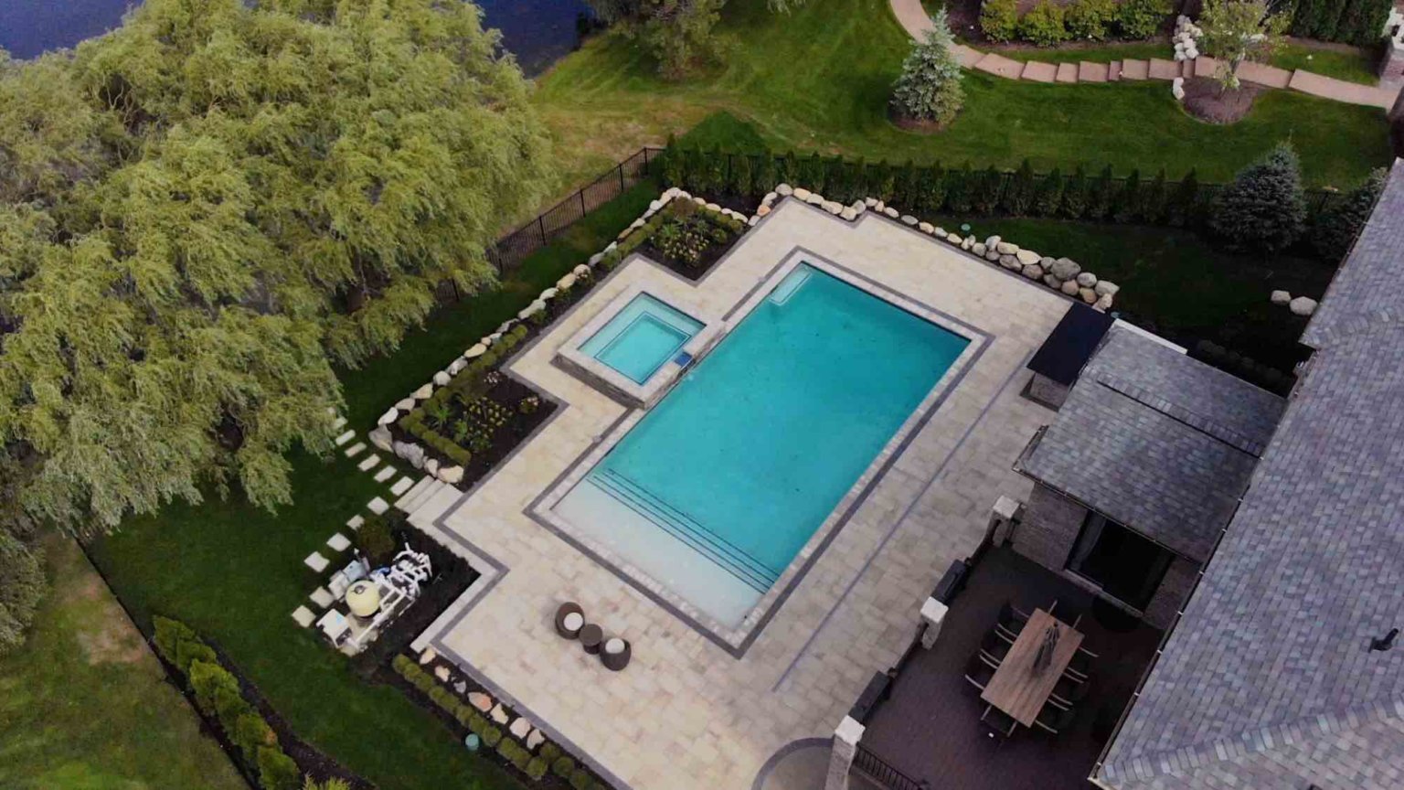 landscape design, michigan pool design, paving company in Michigan, inground pool, pool inspo, backyard pool, pavers, pavers near me, swim and spa, swimming pool design and install, backyard ideas, privacy fence ideas, backyard landscaping ideas, inground pool ideas, gunite pools, pool lights, led pool lights, unilock