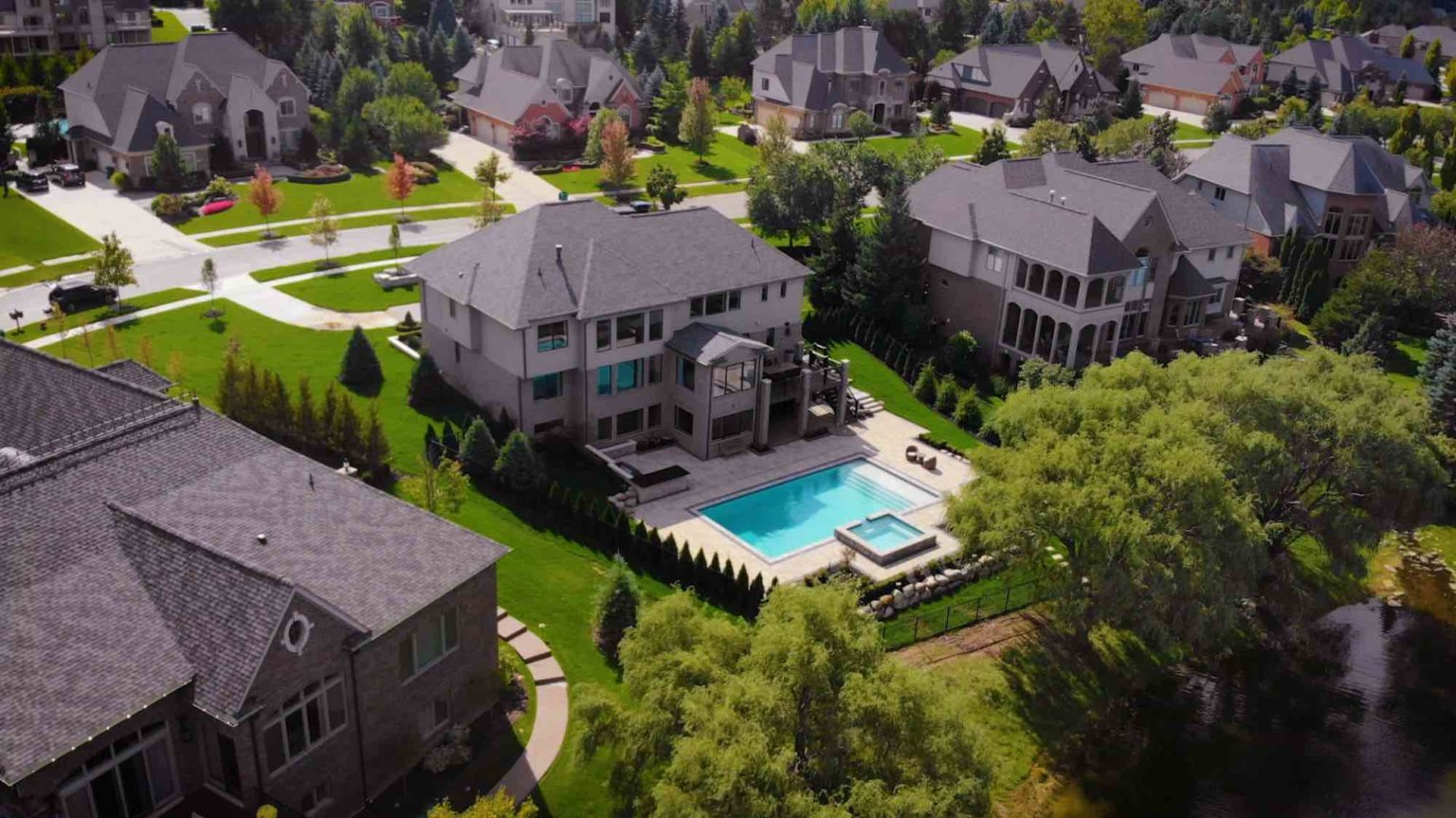 Michigan spa design, spillover spa design, spillover spa inspo, landscape design, michigan pool design, paving company in Michigan, inground pool, pool inspo, backyard pool, pavers, pavers near me, swim and spa, swimming pool design and install, backyard ideas, privacy fence ideas, backyard landscaping ideas, unilock, Oakland county landscapers spillover spa