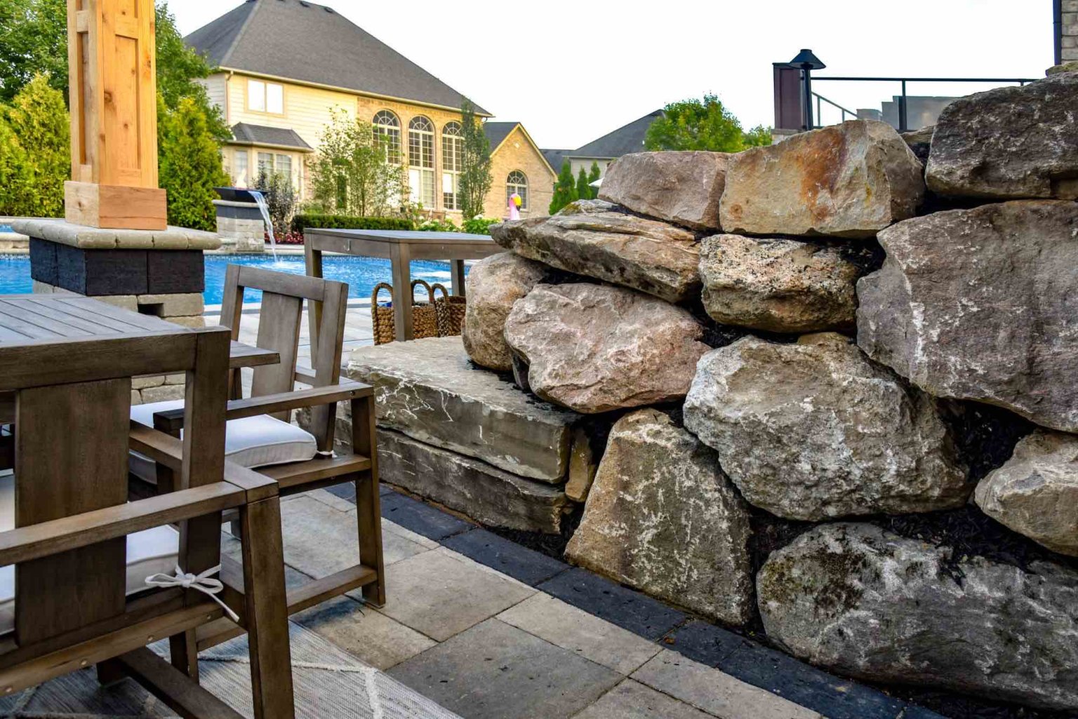 Michigan boulder retaining wall  Natural privacy  Michigan Landscape Design Landscape Design Services in Michigan Professional Landscape Design Michigan Michigan Landscape Architects Best Landscape Designers in Michigan