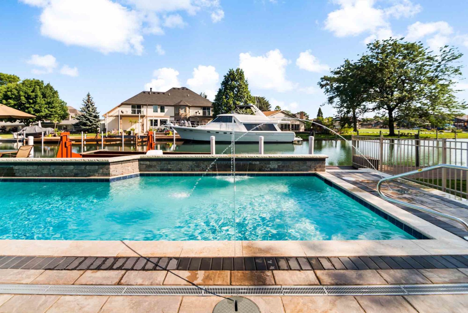 luxury custom gunite swimming pool with jet fountains and sheet fountains Michigan Landscape Design Landscape Design Services in Michigan Professional Landscape Design Michigan Michigan Landscape Architects Best Landscape Designers in Michigan Michigan Residential Landscape Design Custom Landscape Design Michigan Michigan Garden Design Landscape Planning Michigan Landscape Installation Michigan Michigan Pavers Paver Installation Michigan Paver Contractors in Michigan Best Pavers in Michigan