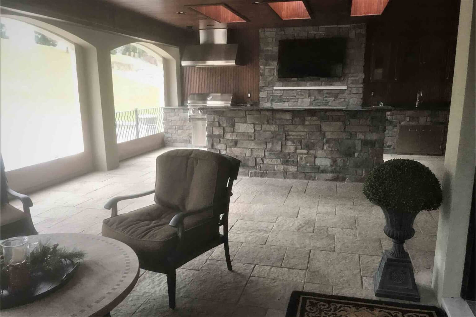 kitchen with bar facing patio seating and outdoor fireplace Michigan Landscape Design Landscape Design Services in Michigan Professional Landscape Design Michigan Michigan Landscape Architects Best Landscape Designers in Michigan Michigan Residential Landscape Design Custom Landscape Design Michigan Michigan Garden Design Landscape Planning Michigan Landscape Installation Michigan Michigan Landscape Renovation Sustainable Landscape Design Michigan Michigan Landscaping Ideas Michigan Hardscape Design Award-Winning Landscape Design Michigan Michigan Four-Season Landscape Design Antonelli Landscape pool spa, pavers near me,