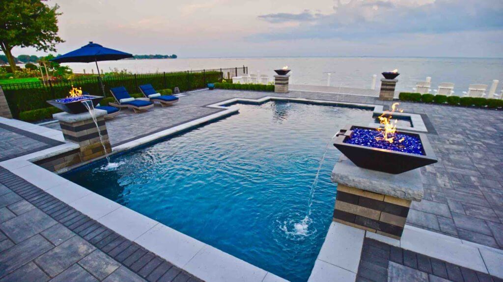 in-ground pool with fire features, brick pavers, fountain professional pool design & installation