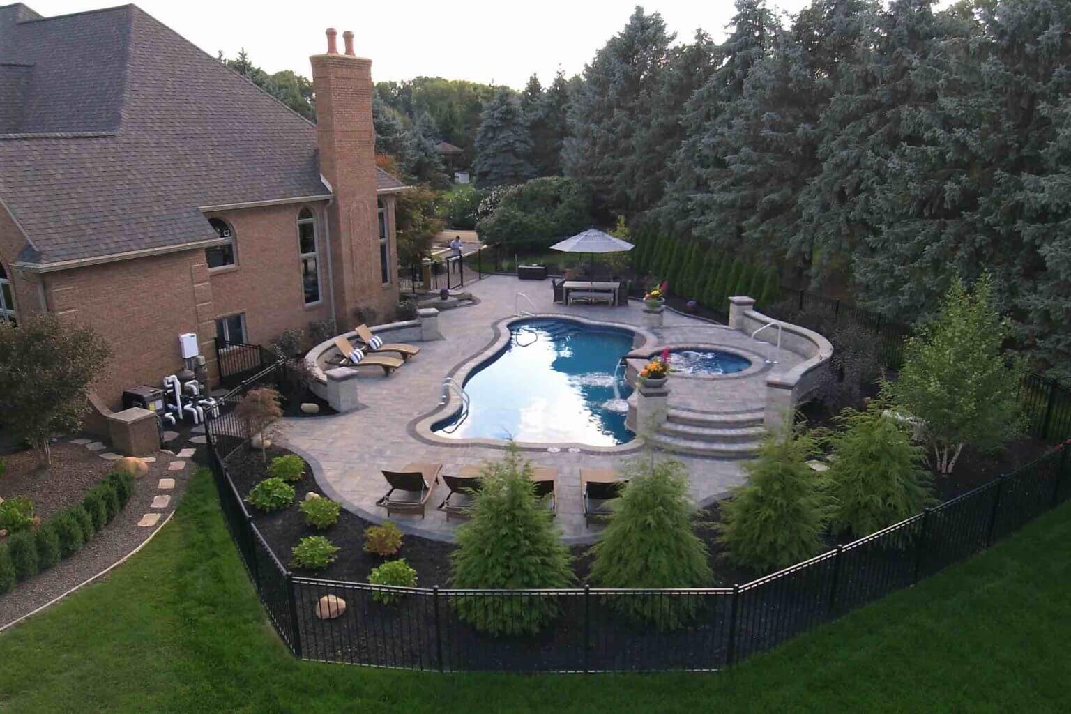aerial view of backyard pool with hot tub spillover attached fiberglass pool and spillover spa in Washington Twp, Michiganfiberglass pool and spillover spa in Washington Twp, Michigan softscape design Michigan Landscape Design Landscape Design Services in Michigan Professional Landscape Design Michigan Michigan Landscape Architects Best Landscape Designers in Michigan Michigan Residential Landscape Design Custom Landscape Design Michigan