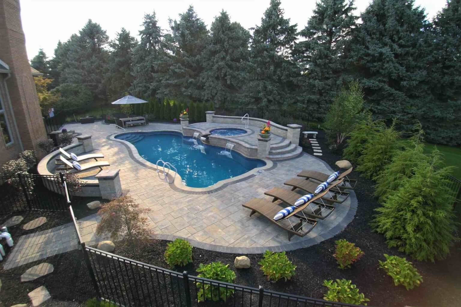 pool with a spillover hot tub softscape design patio design in Metro Detroit Custom inground pools Backyard pool ideas detroit Michigan Pavers Paver Installation Michigan Paver Contractors in Michigan Best Pavers in Michigan Michigan Patio Pavers Driveway Pavers Michigan Walkway Pavers Michigan Michigan Paver Stones Custom Pavers Michigan Michigan Paver Design pool and spa design Metro Detroit Metro Detroit pool and spa experts Custom pool design Metro Detroit Spa installation in Metro Detroit Metro Detroit outdoor spa design Residential pool design Metro Detroit Metro Detroit luxury pool and spa