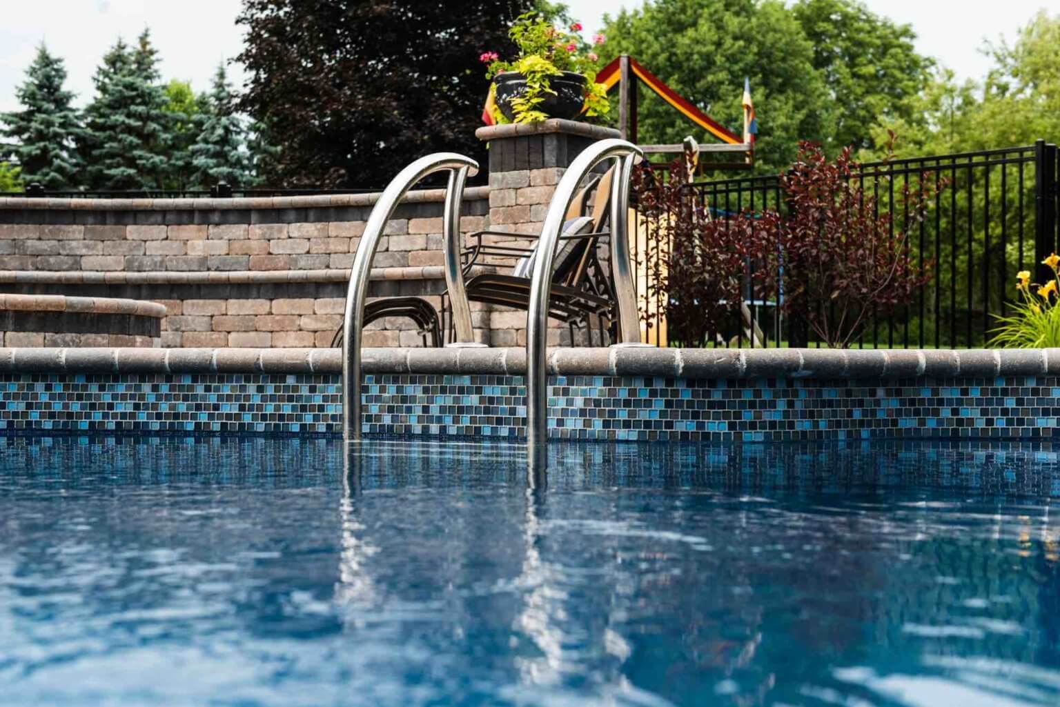entry ladder into pool fiberglass pool and spillover spa Michigan Pavers Paver Installation Michigan Paver Contractors in Michigan Best Pavers in Michigan Michigan Patio Pavers Driveway Pavers Michigan Walkway Pavers Michigan