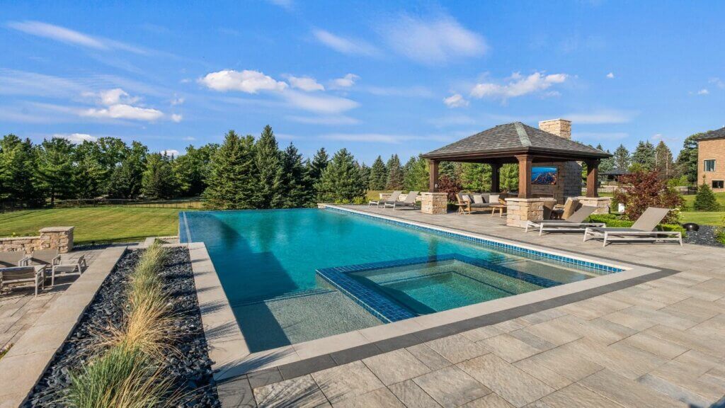 Livin On The Edge - Oakland Township, MI custom inground pool Oakland Township mi Michigan Landscape Design Landscape Design Services in Michigan Professional Landscape Design Michigan Michigan Landscape Architects Best Landscape Designers in Michigan Michigan Residential Landscape Design Custom Landscape Design Michigan Michigan Garden Design Landscape Planning Michigan Michigan Pavers Paver Installation Michigan Paver Contractors in Michigan Best Pavers in Michigan Michigan Patio Pavers Driveway Pavers Michigan Walkway Pavers Michigan Michigan Paver Stones Custom Pavers Michigan Michigan Paver Design Paver Repair Michigan Paver Maintenance Michigan Interlocking Pavers Michigan Concrete Pavers Michigan Brick Pavers Michigan pool and spa design Metro Detroit Metro Detroit pool and spa experts Custom pool design Metro Detroit Spa installation in Metro Detroit Metro Detroit outdoor spa design Residential pool design Metro Detroit Metro Detroit luxury pool and spa Pool and spa renovation Metro Detroit Metro Detroit backyard pool design Metro Detroit pool and spa builders Metro Detroit pool and spa contractors Patio designs detroit mi Patio company Outdoor living contractor oak Backyard pool ideas detroit Landscape lighting Oakland twp mi Custom pool and spa builders near me Patio companies