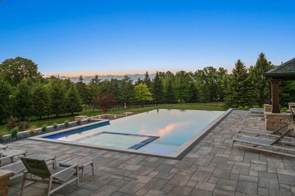 Livin On The Edge - Oakland Township, MI custom inground pool Oakland Township mi Michigan Landscape Design Landscape Design Services in Michigan Professional Landscape Design Michigan Michigan Landscape Architects Best Landscape Designers in Michigan Michigan Residential Landscape Design Custom Landscape Design Michigan Michigan Garden Design Landscape Planning Michigan Michigan Pavers Paver Installation Michigan Paver Contractors in Michigan Best Pavers in Michigan Michigan Patio Pavers Driveway Pavers Michigan Walkway Pavers Michigan Michigan Paver Stones Custom Pavers Michigan Michigan Paver Design Paver Repair Michigan Paver Maintenance Michigan Interlocking Pavers Michigan Concrete Pavers Michigan Brick Pavers Michigan pool and spa design Metro Detroit Metro Detroit pool and spa experts Custom pool design Metro Detroit Spa installation in Metro Detroit Metro Detroit outdoor spa design Residential pool design Metro Detroit Metro Detroit luxury pool and spa Pool and spa renovation Metro Detroit Metro Detroit backyard pool design Metro Detroit pool and spa builders Metro Detroit pool and spa contractors pool designers near me patio designs with pool, custom inground pools professional pool design & installation