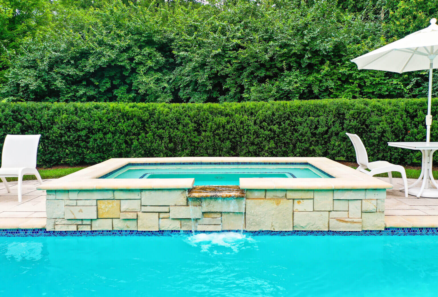 Michigan spa design, spillover spa design, spillover spa inspo, landscape design, michigan pool design, paving company in Michigan, inground pool, pool inspo, backyard pool, pavers, pavers near me, swim and spa, swimming pool design and install, backyard ideas, privacy fence ideas, backyard landscaping ideas, unilock brick paving in Bloomfield