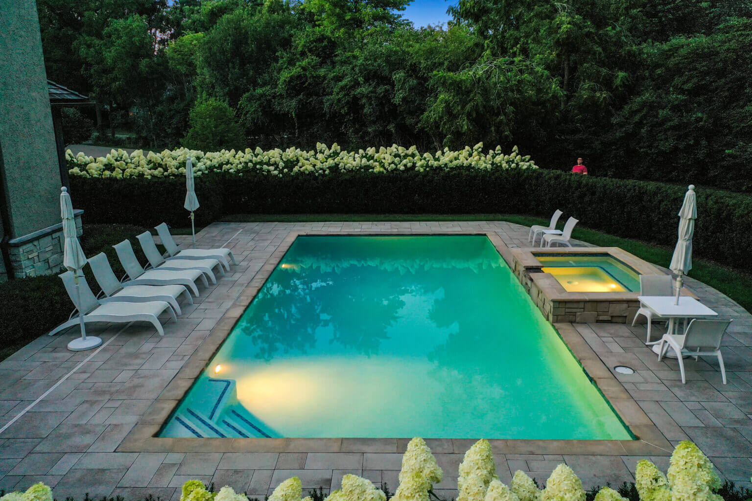 landscape design, michigan pool design, paving company in Michigan, inground pool, pool inspo, backyard pool, pavers, pavers near me, swim and spa, swimming pool design and install, backyard ideas, privacy fence ideas, backyard landscaping ideas, inground pool ideas, gunite pools, pool lights, led pool lights, unilock brick paving in Bloomfield