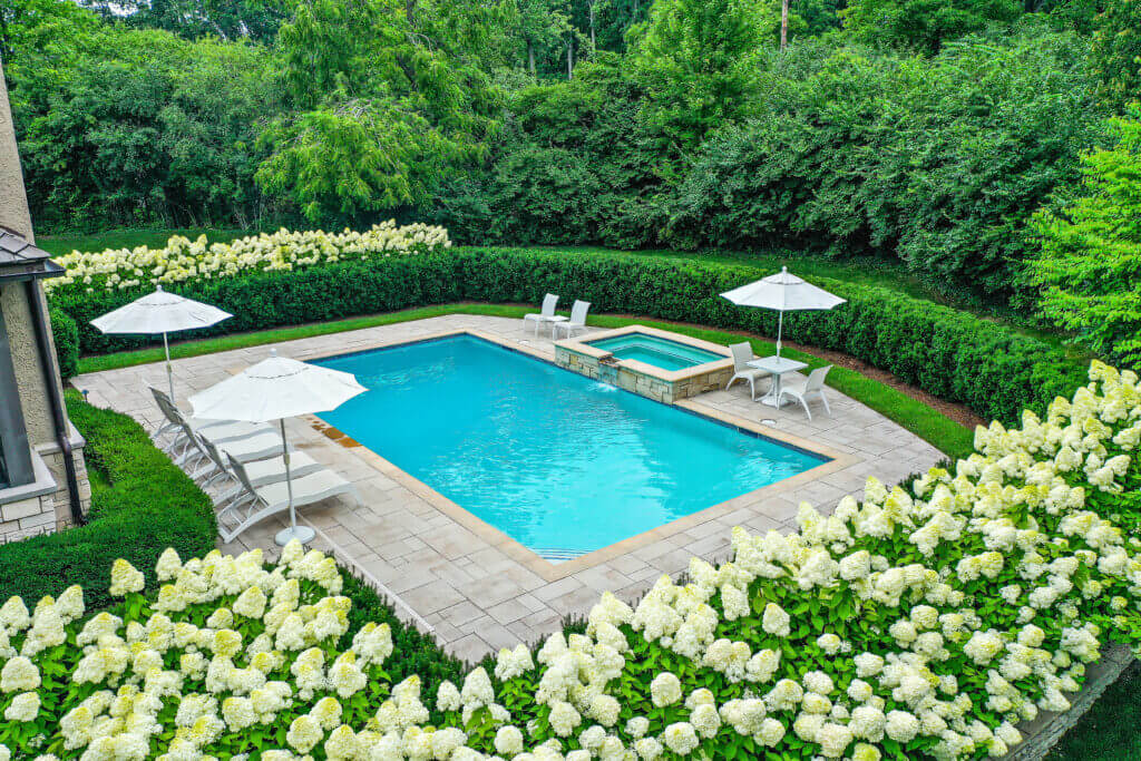 landscape design, michigan pool design, paving company in Michigan, inground pool, pool inspo, backyard pool, pavers, pavers near me, swim and spa, swimming pool design and install, backyard ideas, privacy fence ideas, backyard landscaping ideas, stone paving, pool paving, unilock brick paving in Bloomfield pool designers near me patio designs with pool, custom inground pools professional pool design & installation