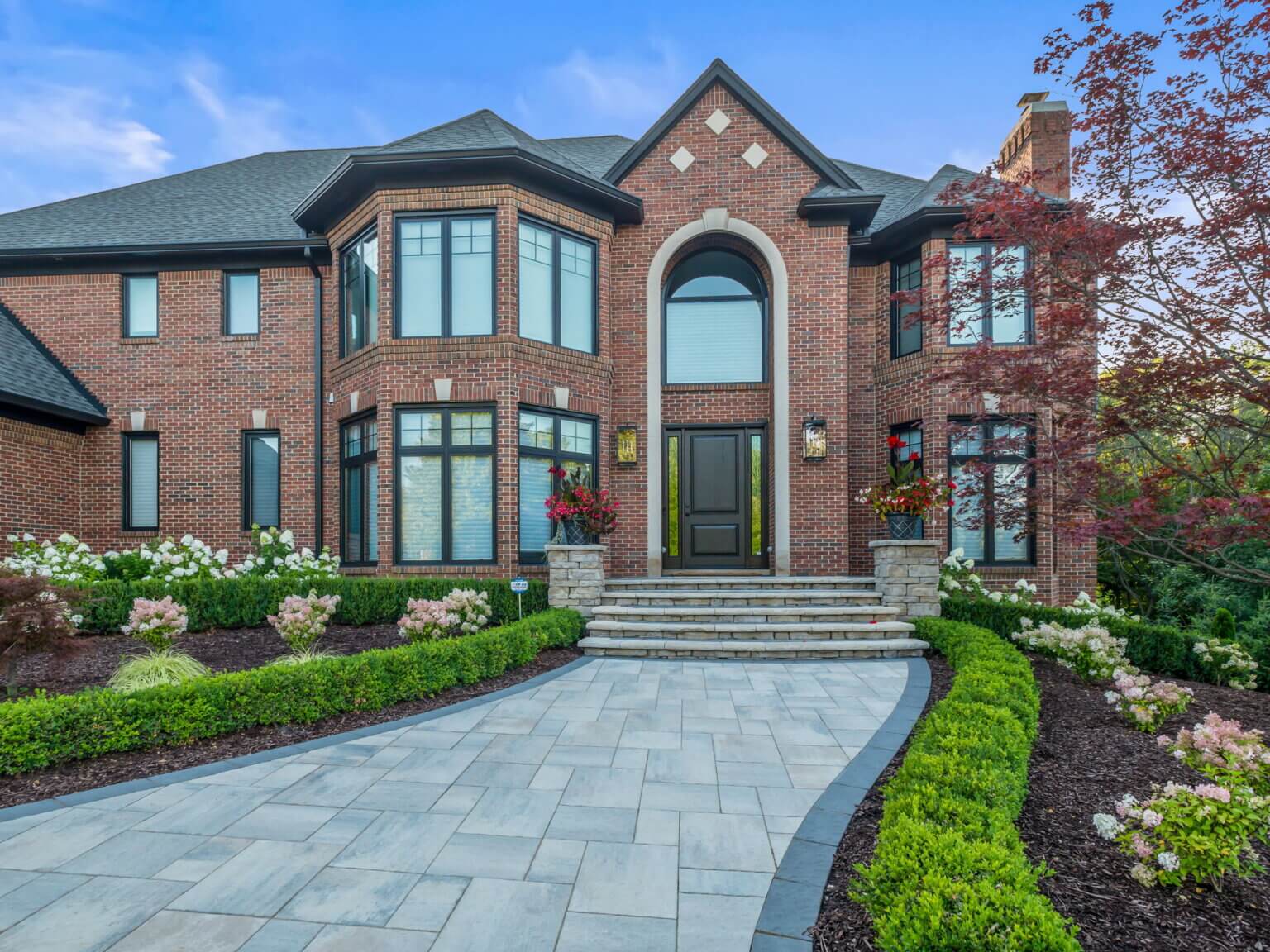 Front yard pavers Michigan Michigan front yard landscaping with pavers Front yard paving stones in Michigan Front yard hardscape design Michigan Michigan front yard patio pavers Front yard walkway pavers Michigan