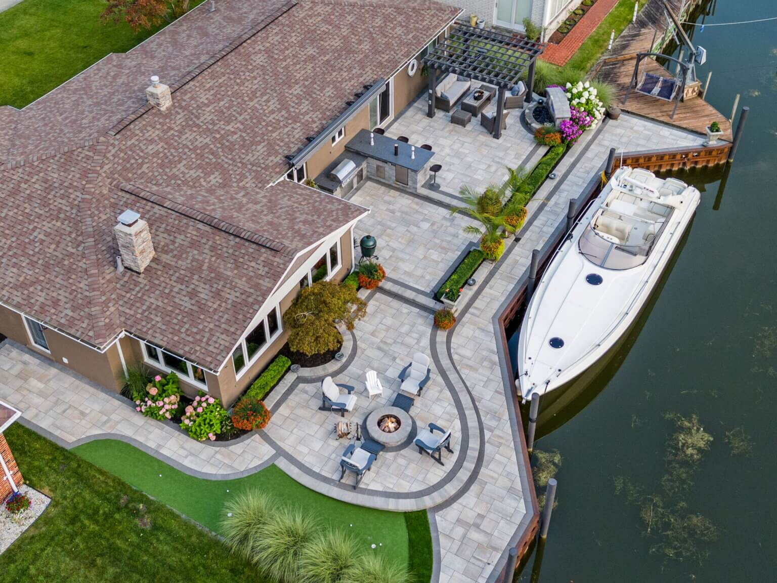 Complete front and backyard landscape Pergola Outdoor kitchen Wood burning fire pit Multi level paver slab patio along canal Brick paver walkway Outdoor Fire Features Fire Pit Designs Fire Feature Ideas Gas Fire Pits Outdoor Fireplaces Fire Pit Installation Custom Fire Features Backyard Fire Features Fire Pit Safety