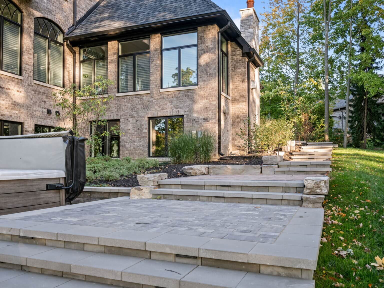 Unilock paving stone Unilock retaining walls Unilock coping  Michigan fieldstone boulders Limestone outcropping 