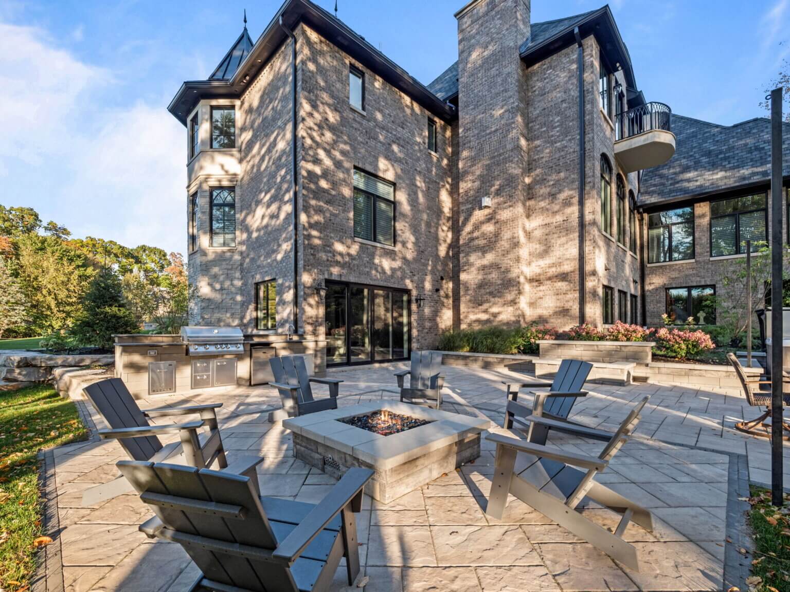 Outdoor Fire Features Fire Pit Designs Fire Feature Ideas Gas Fire Pits Outdoor Fireplaces Fire Pit Installation Custom Fire Features Unilock paving stone Unilock retaining walls Unilock coping  Michigan fieldstone boulders Limestone outcropping 